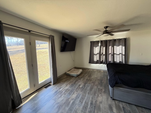 bedroom featuring hardwood / wood-style flooring, ceiling fan, and a textured ceiling