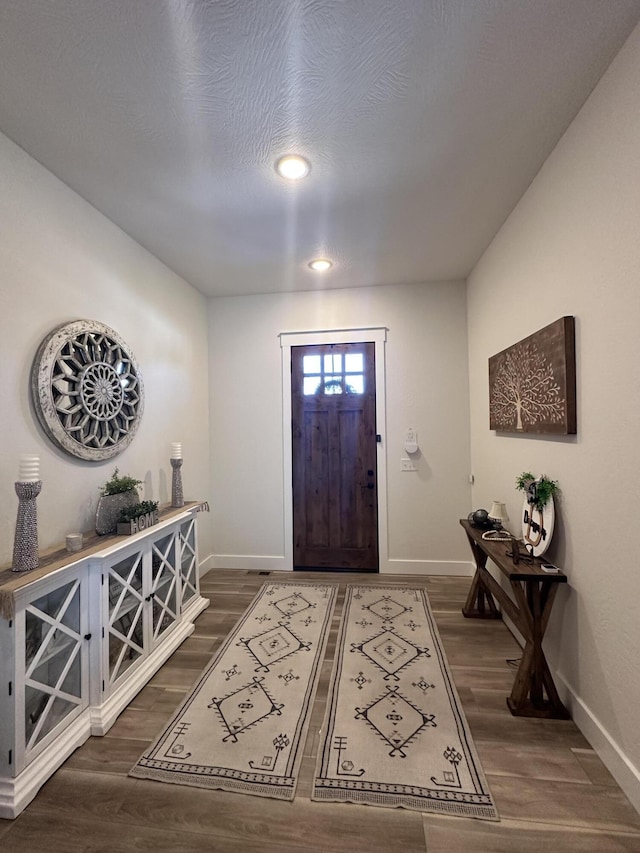 entrance foyer featuring dark hardwood / wood-style floors and a textured ceiling