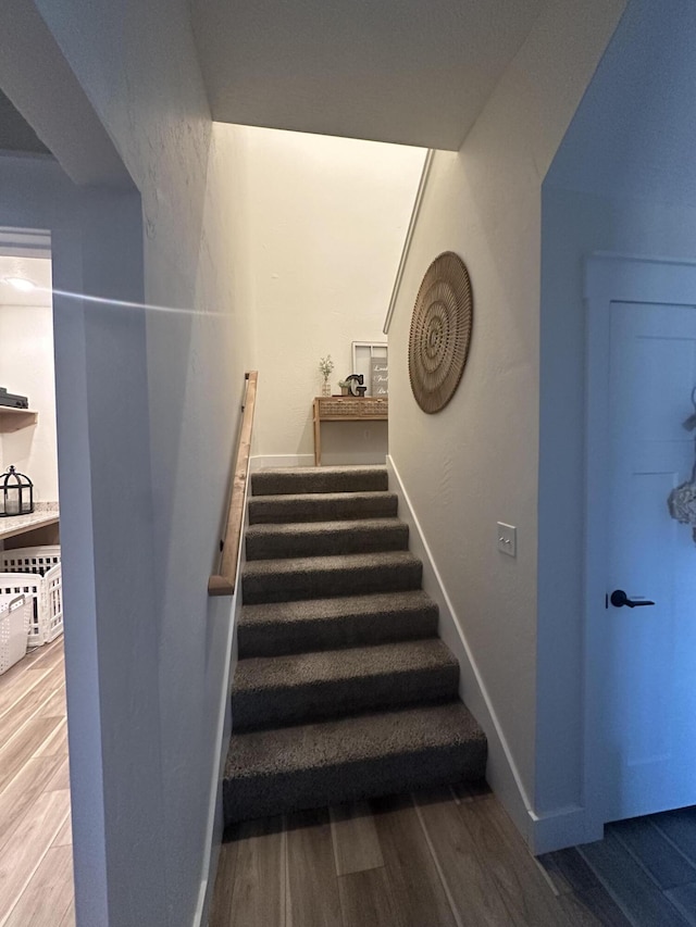 stairway featuring hardwood / wood-style flooring