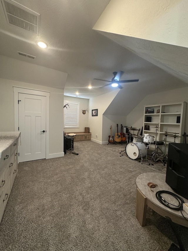 interior space with vaulted ceiling, ceiling fan, and carpet flooring