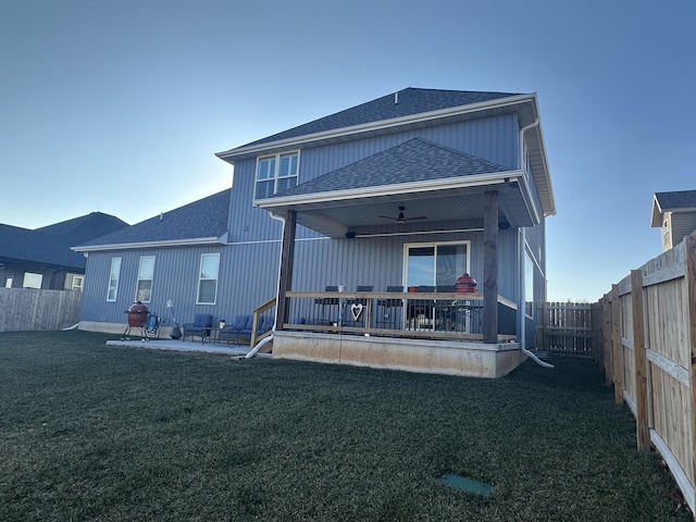 back of property featuring a yard, a patio, and ceiling fan