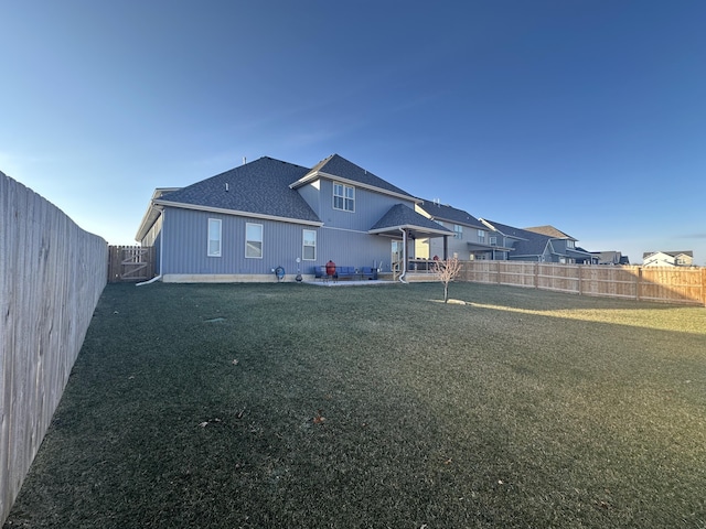 back of house with a patio and a yard