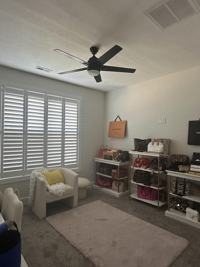 interior space featuring ceiling fan and carpet flooring