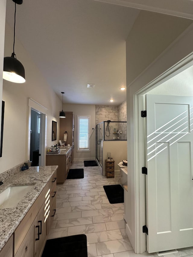 bathroom with vanity and shower with separate bathtub