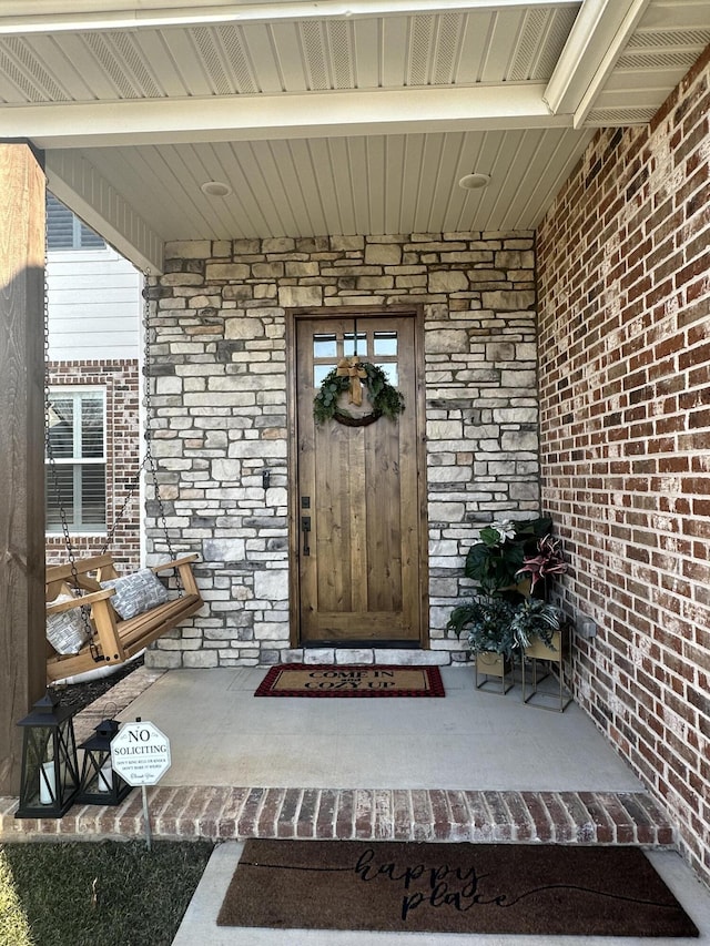 view of exterior entry featuring a porch