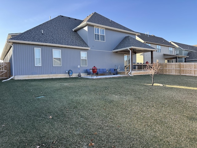 rear view of house with a patio area and a lawn