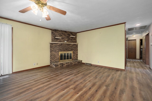 unfurnished living room featuring a brick fireplace, crown molding, dark wood-type flooring, and ceiling fan