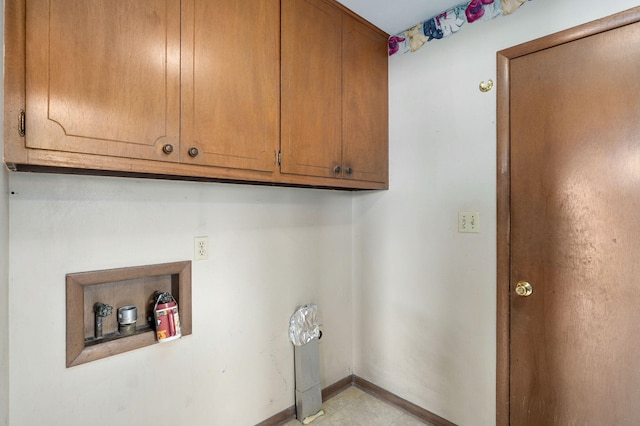 laundry room featuring cabinets