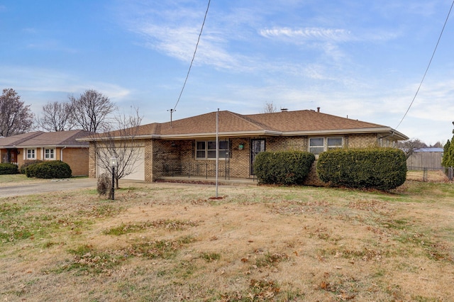 ranch-style home with a garage and a front yard