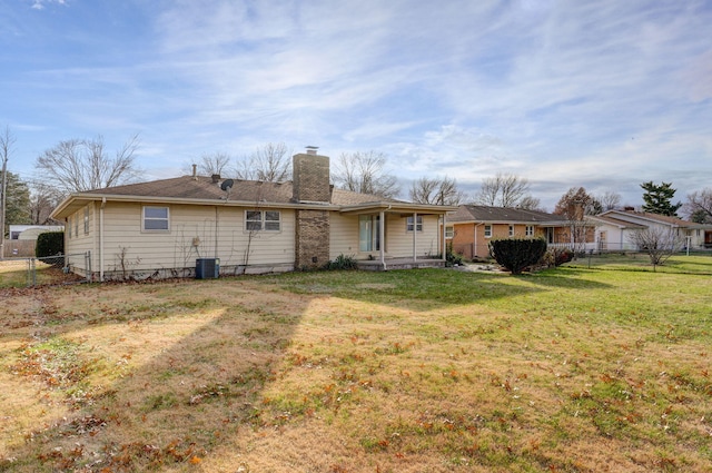 rear view of house with a yard