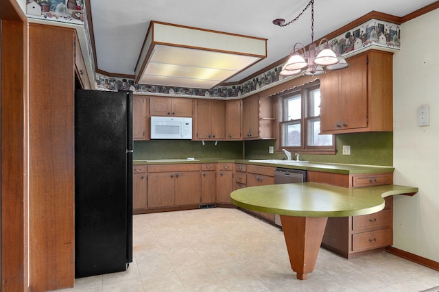 kitchen with hanging light fixtures, tasteful backsplash, black fridge, and stainless steel dishwasher