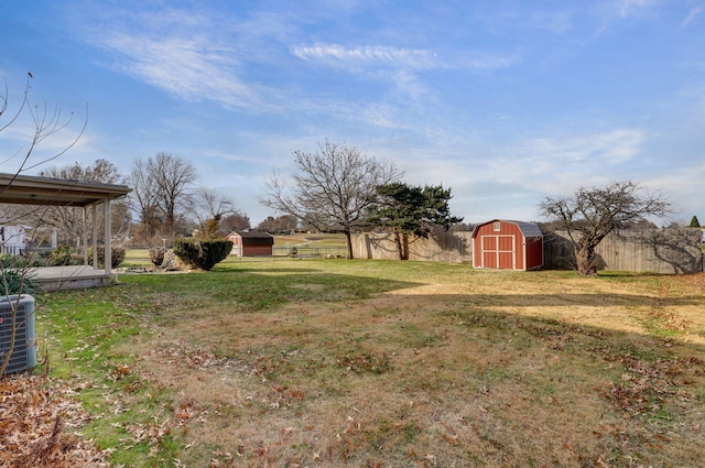 view of yard with a shed and central AC