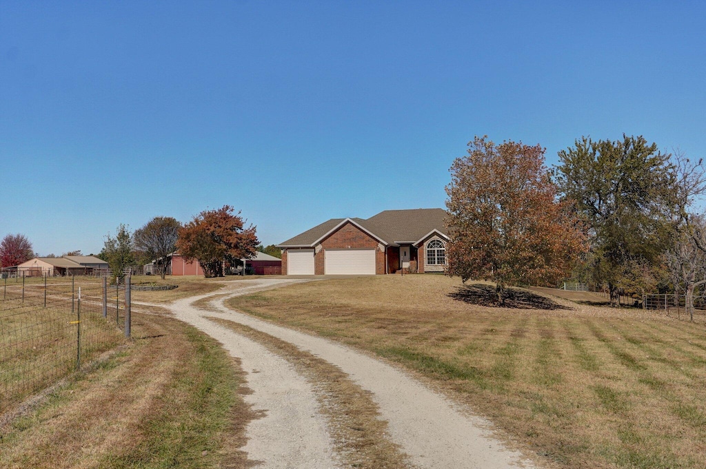 exterior space featuring a garage and a front lawn