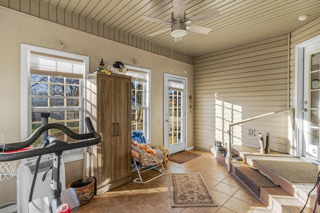 sunroom / solarium featuring wooden ceiling and ceiling fan