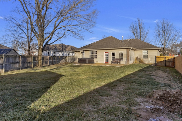 rear view of house featuring a yard and a patio area