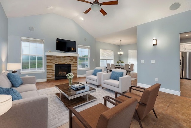 tiled living room featuring ceiling fan, a fireplace, and high vaulted ceiling