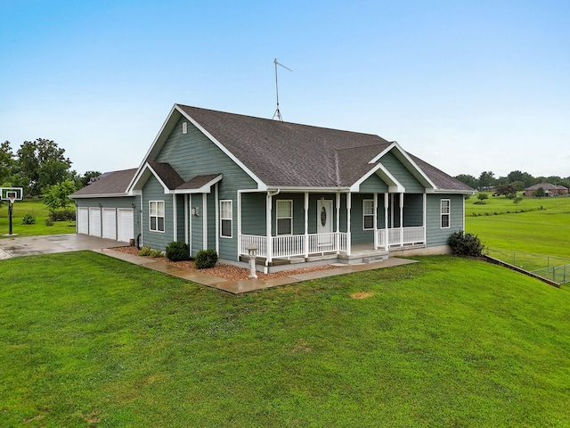 view of front of property with a garage, covered porch, and a front lawn