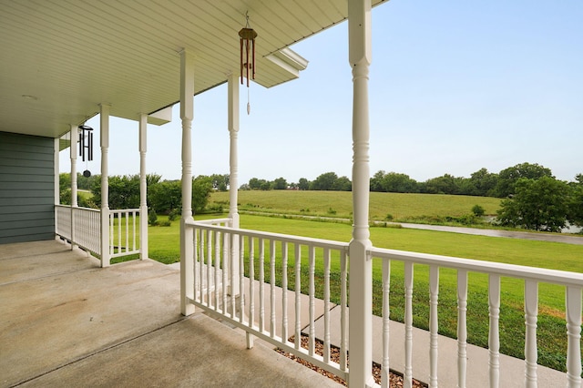 view of patio / terrace with a porch and a rural view