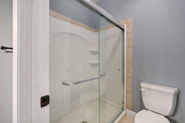 bathroom with walk in shower and toilet