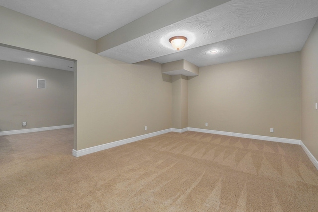 basement with a textured ceiling and carpet