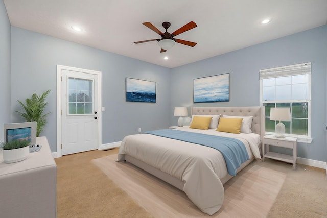 bedroom featuring light carpet and ceiling fan