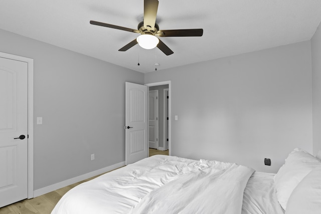 bedroom with ceiling fan and light hardwood / wood-style floors