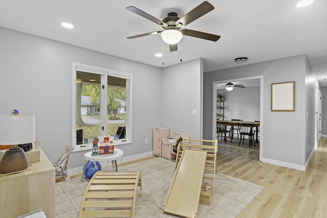 game room with ceiling fan and light hardwood / wood-style floors