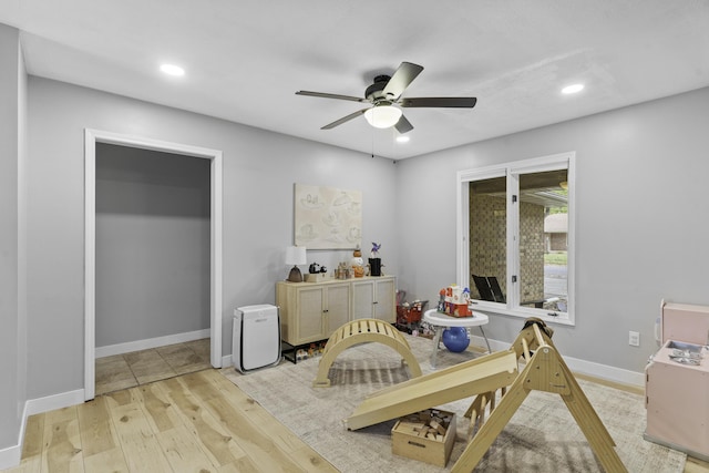 playroom featuring ceiling fan and light wood-type flooring