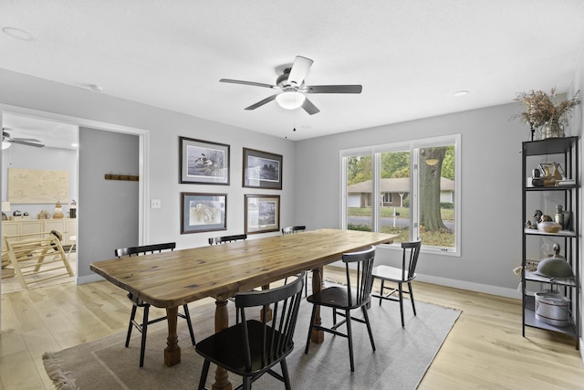 dining area featuring ceiling fan and light wood-type flooring