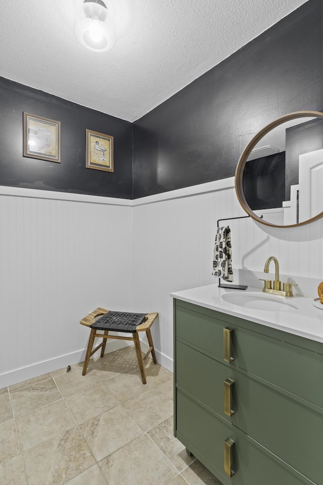 bathroom with vanity, tile patterned floors, and a textured ceiling