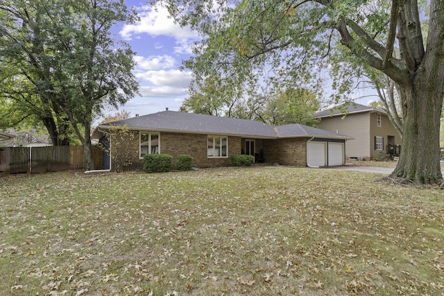 rear view of house with a garage and a lawn