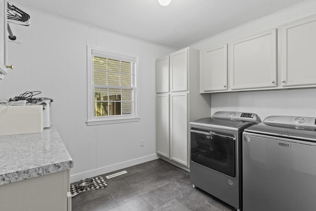 laundry area with independent washer and dryer, ornamental molding, and cabinets