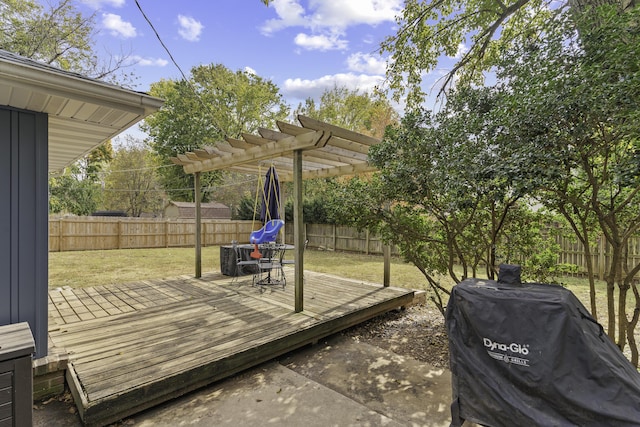 deck with grilling area, a pergola, and a lawn