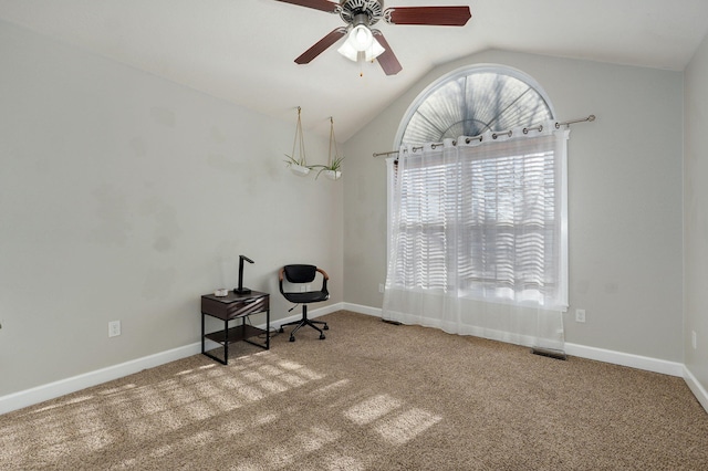 unfurnished office with ceiling fan, carpet floors, and vaulted ceiling