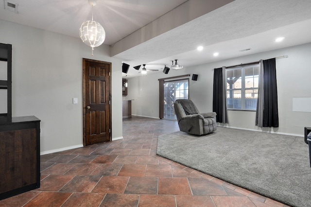 living room with ceiling fan with notable chandelier