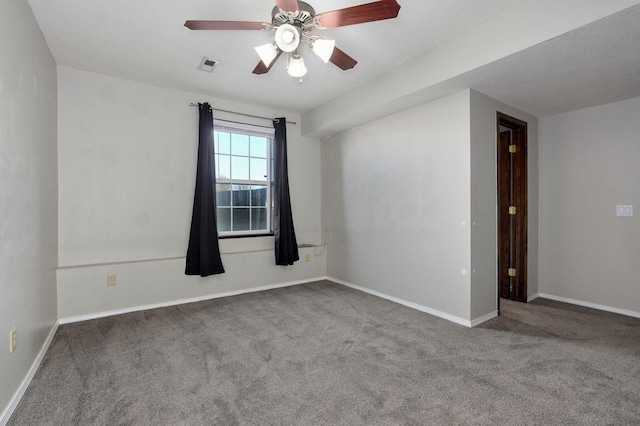 empty room with ceiling fan and carpet flooring