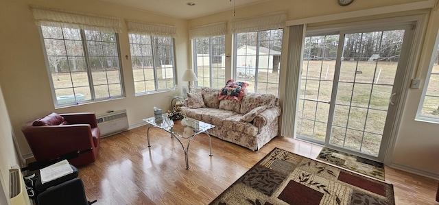 sunroom / solarium featuring a wall mounted air conditioner