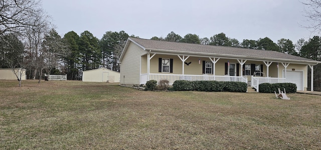 view of front facade featuring a storage shed, covered porch, and a front lawn