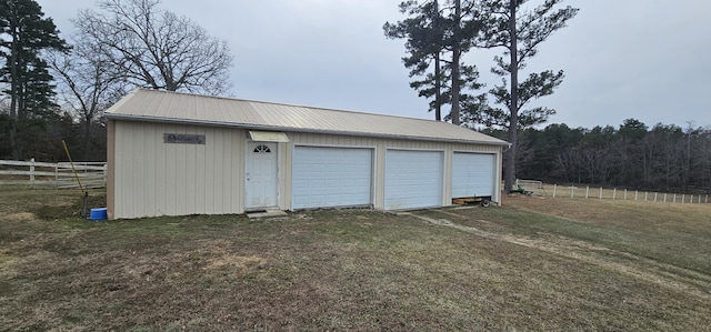 garage featuring a lawn