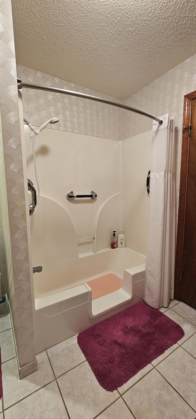 bathroom featuring tile patterned flooring, a textured ceiling, and shower / bath combo with shower curtain