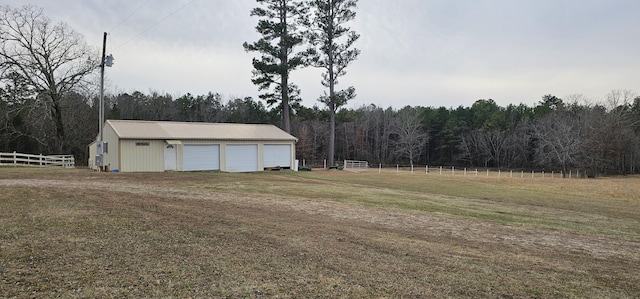 view of yard featuring an outbuilding and a garage