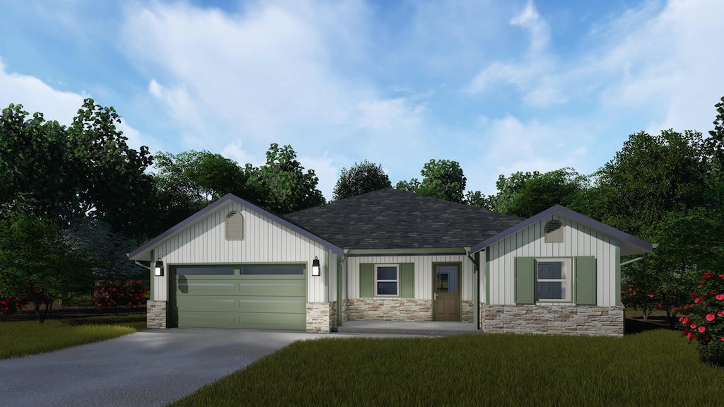 view of front of home featuring a garage and a front yard