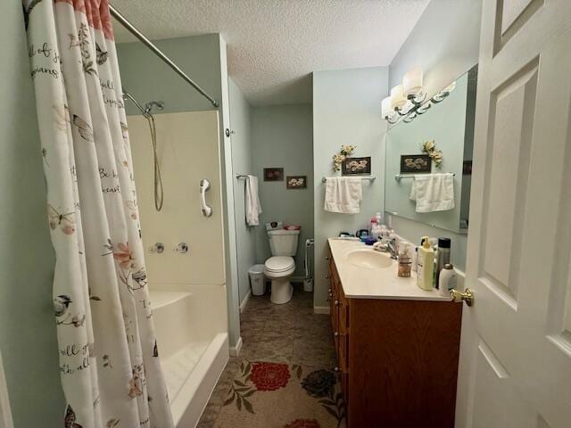 bathroom with vanity, toilet, curtained shower, and a textured ceiling