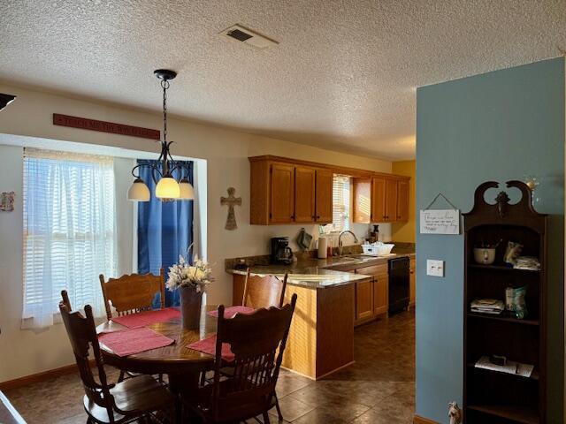 dining space with sink and a textured ceiling