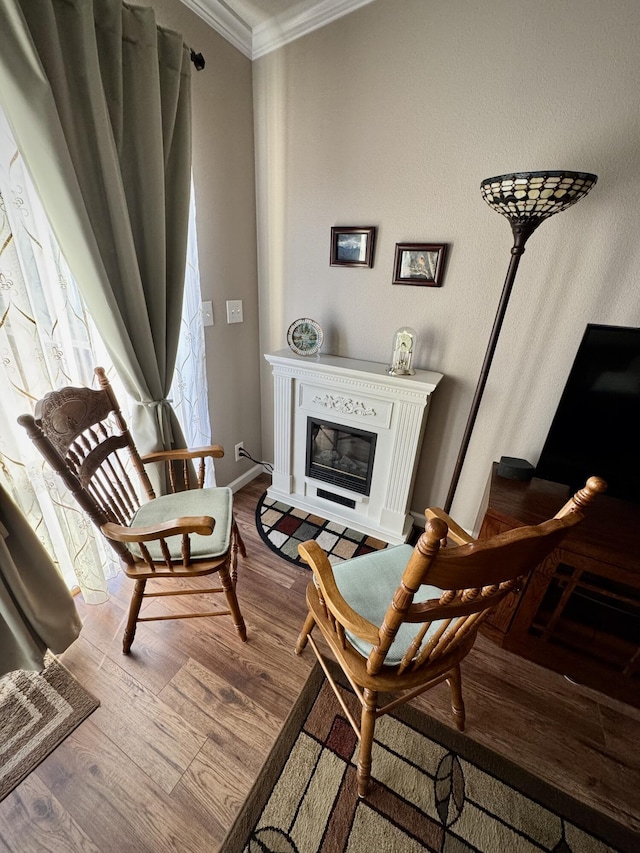 sitting room featuring crown molding and hardwood / wood-style flooring