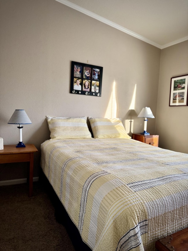 bedroom with ornamental molding and dark carpet