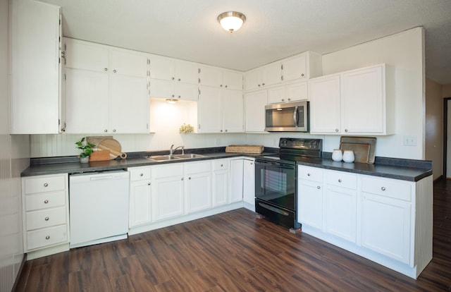 kitchen featuring dishwasher, black electric range, and white cabinets