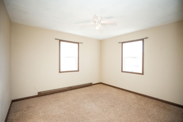 carpeted empty room featuring ceiling fan and a baseboard radiator