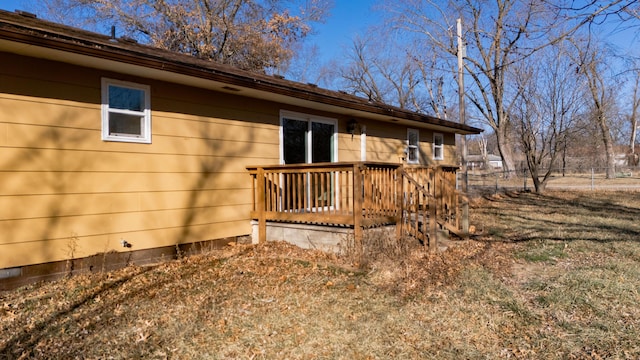 view of side of home with a wooden deck