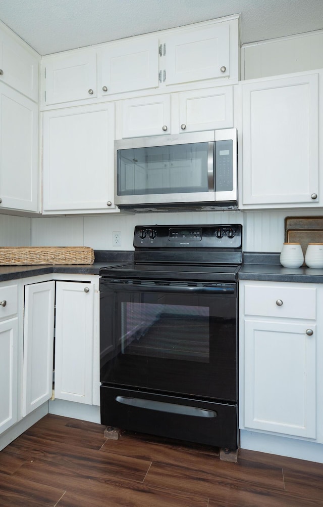 kitchen with white cabinetry, dark wood-type flooring, and black range with electric cooktop